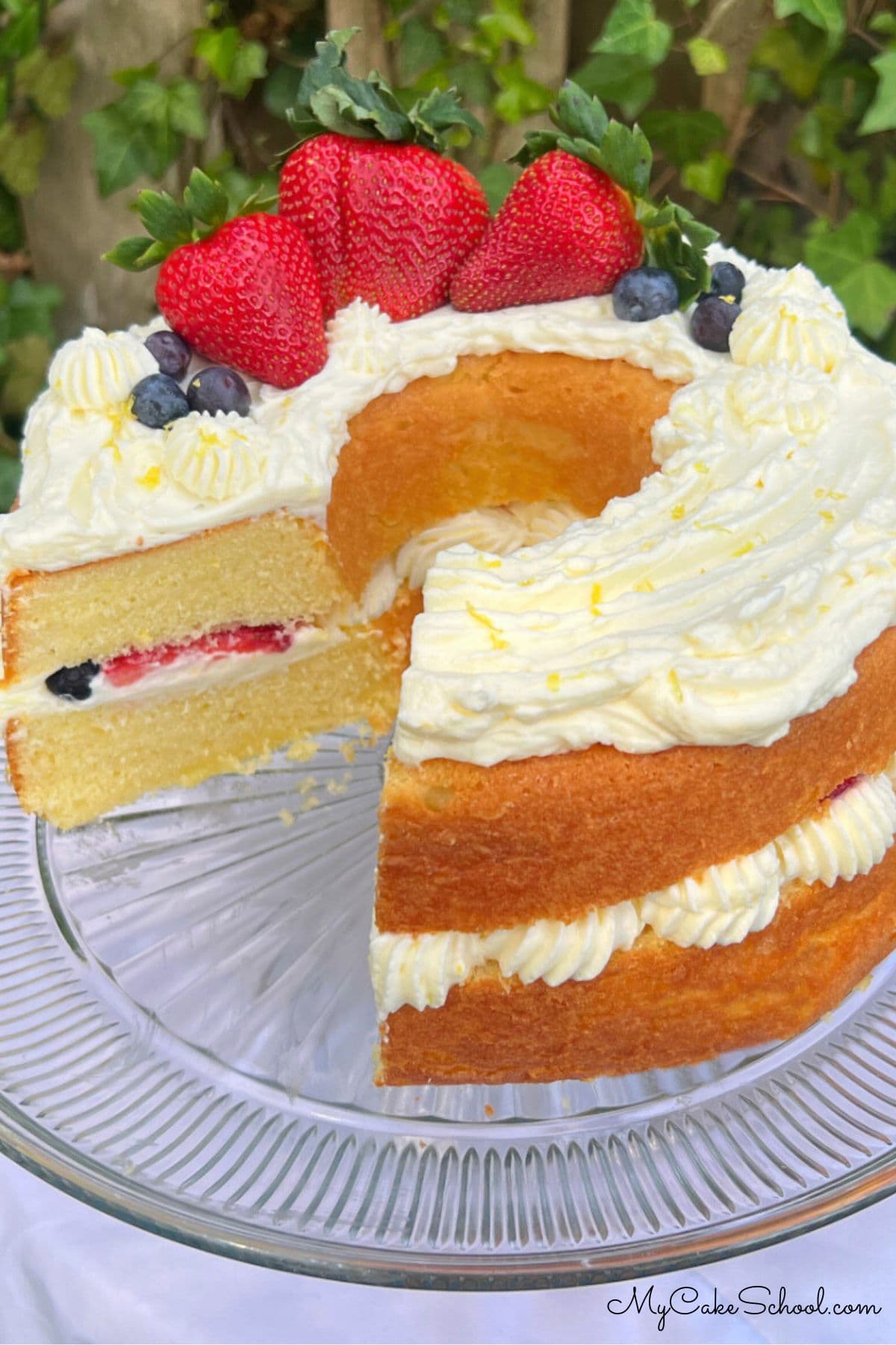 Lemon Berry Bundt Cake, sliced, on a cake pedestal.