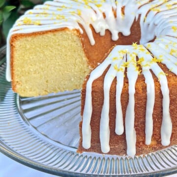 Lemon Ricotta Cake, sliced, on a pedestal.