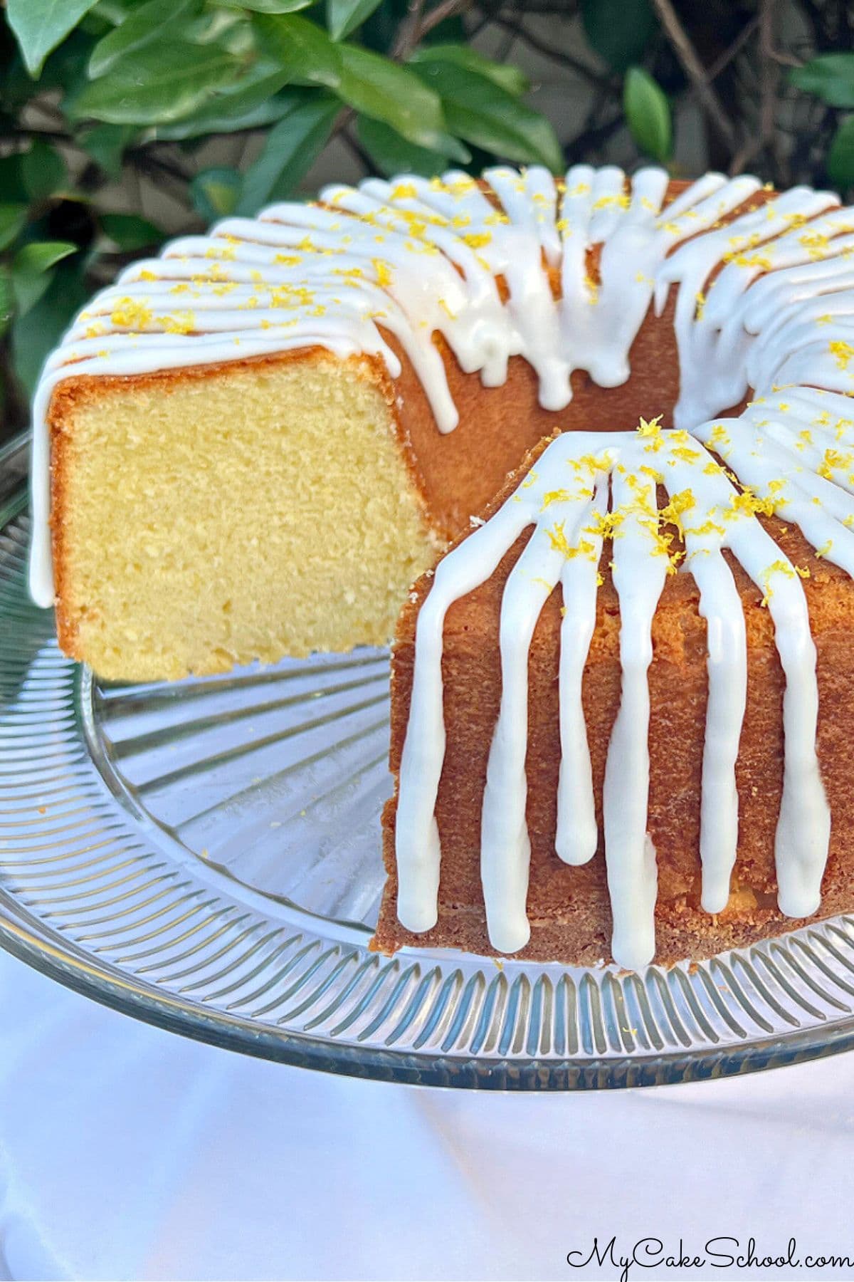 Lemon Ricotta Cake, sliced, on a pedestal.