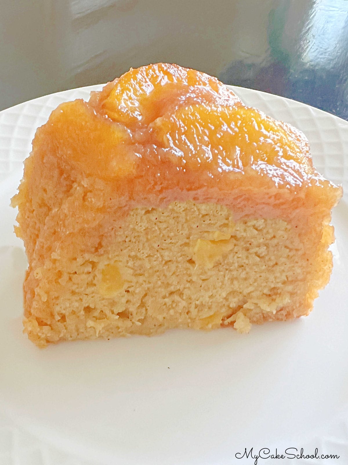 Slice of Peach Upside Down Cake on a plate.