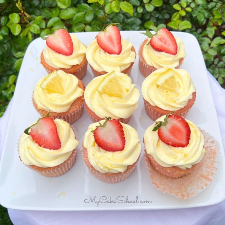Strawberry Lemonade Cupcakes on a cake platter.