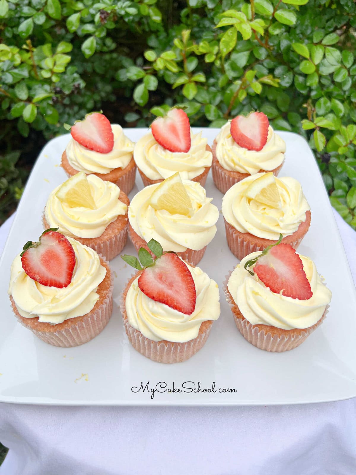 Strawberry Lemonade Cupcakes on a cake platter.