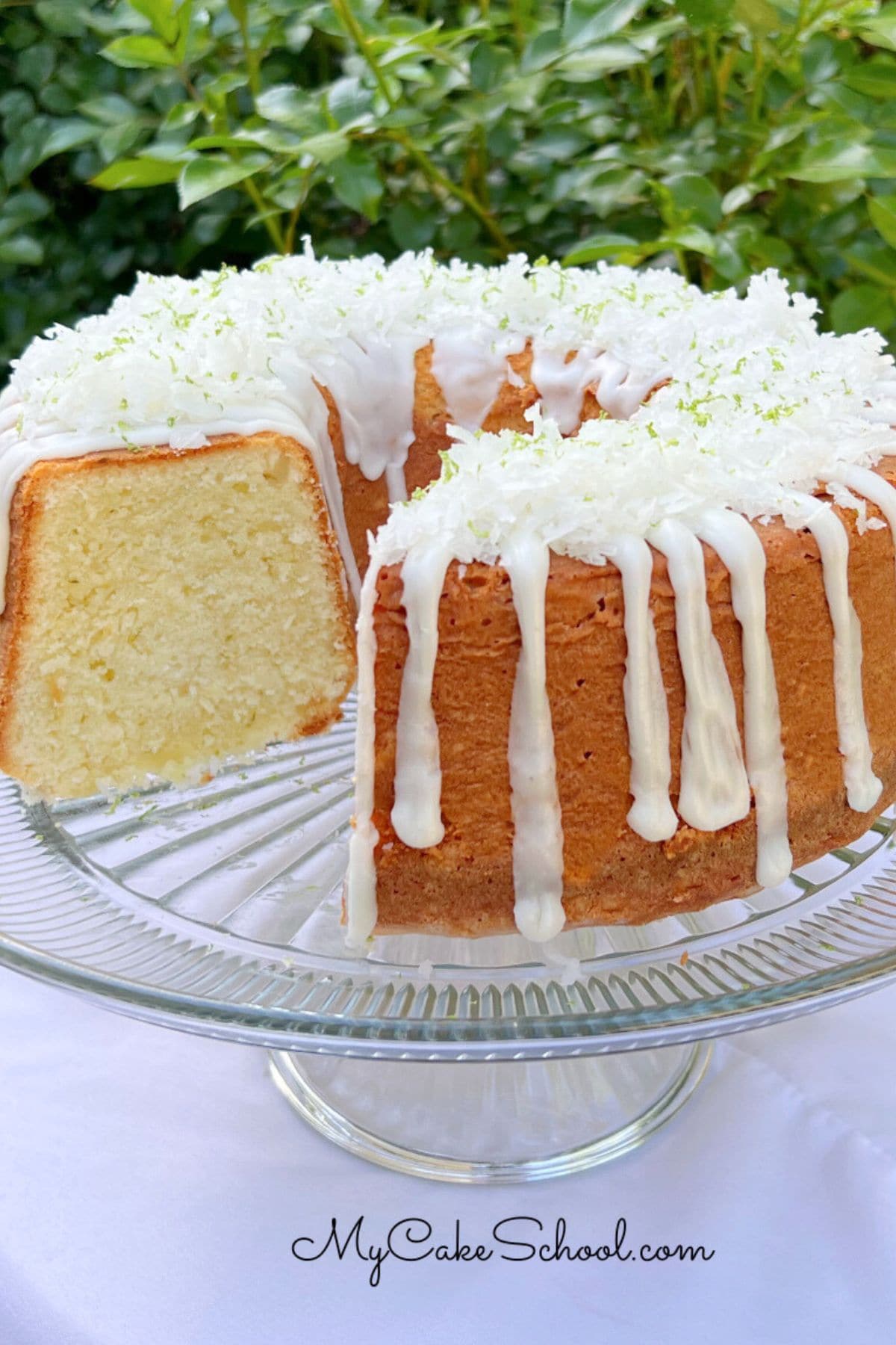 Coconut Lime Pound Cake, sliced, on a cake pedestal.