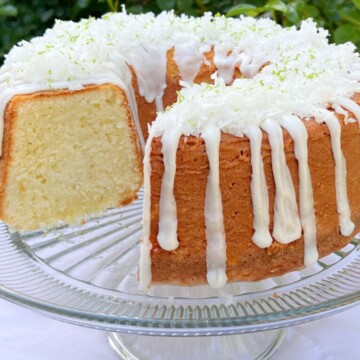 Coconut Lime Pound Cake, sliced, on a cake pedestal.