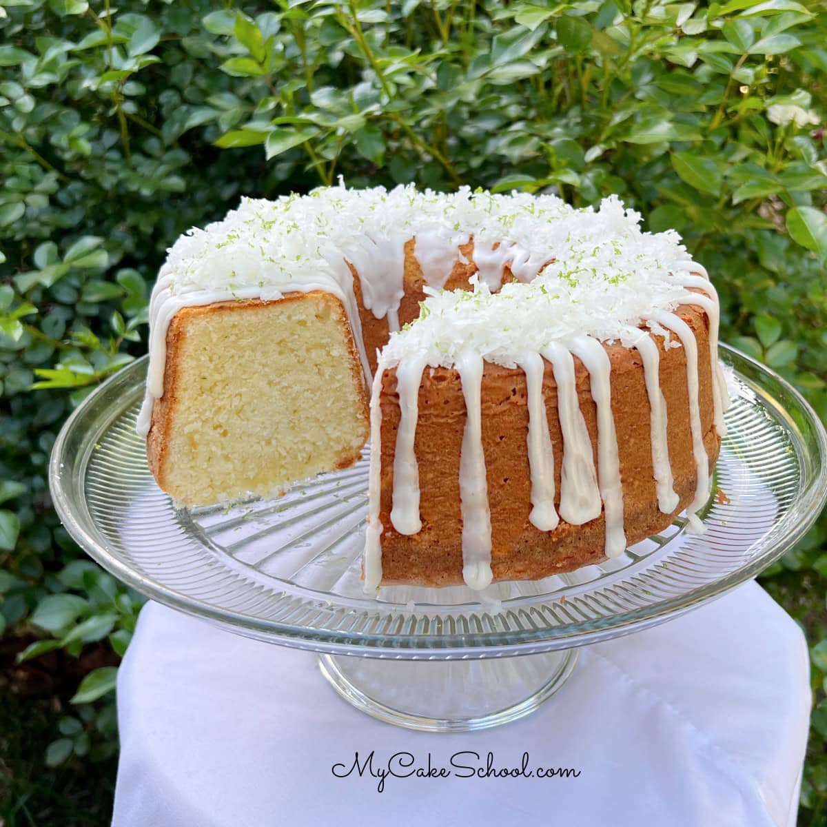 Coconut Lime Pound Cake, sliced, on a pedestal.