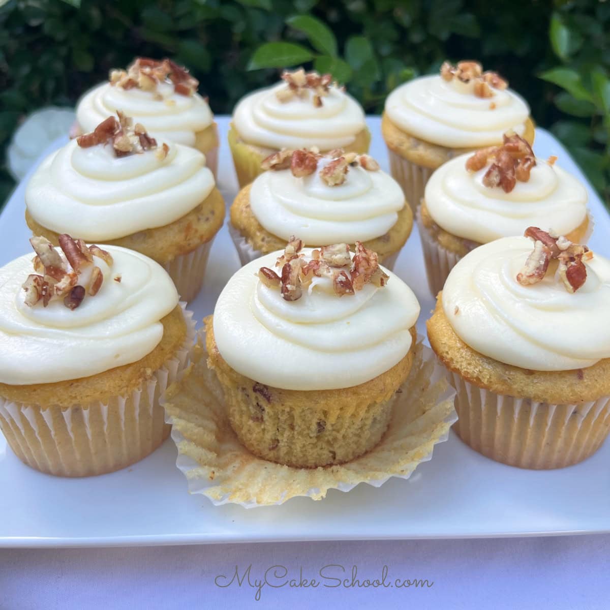 Butter Pecan Cupcakes on a cake platter.