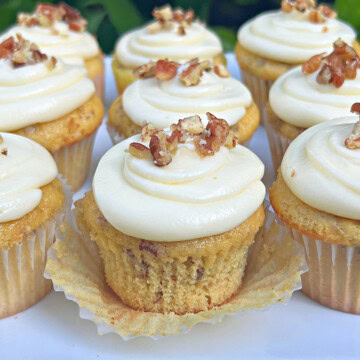 Butter pecan cupcakes on a cake platter.