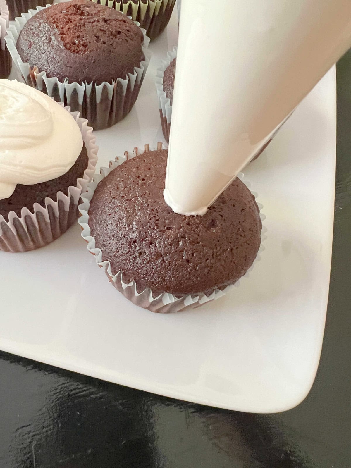 Filling the chocolate cupcakes.