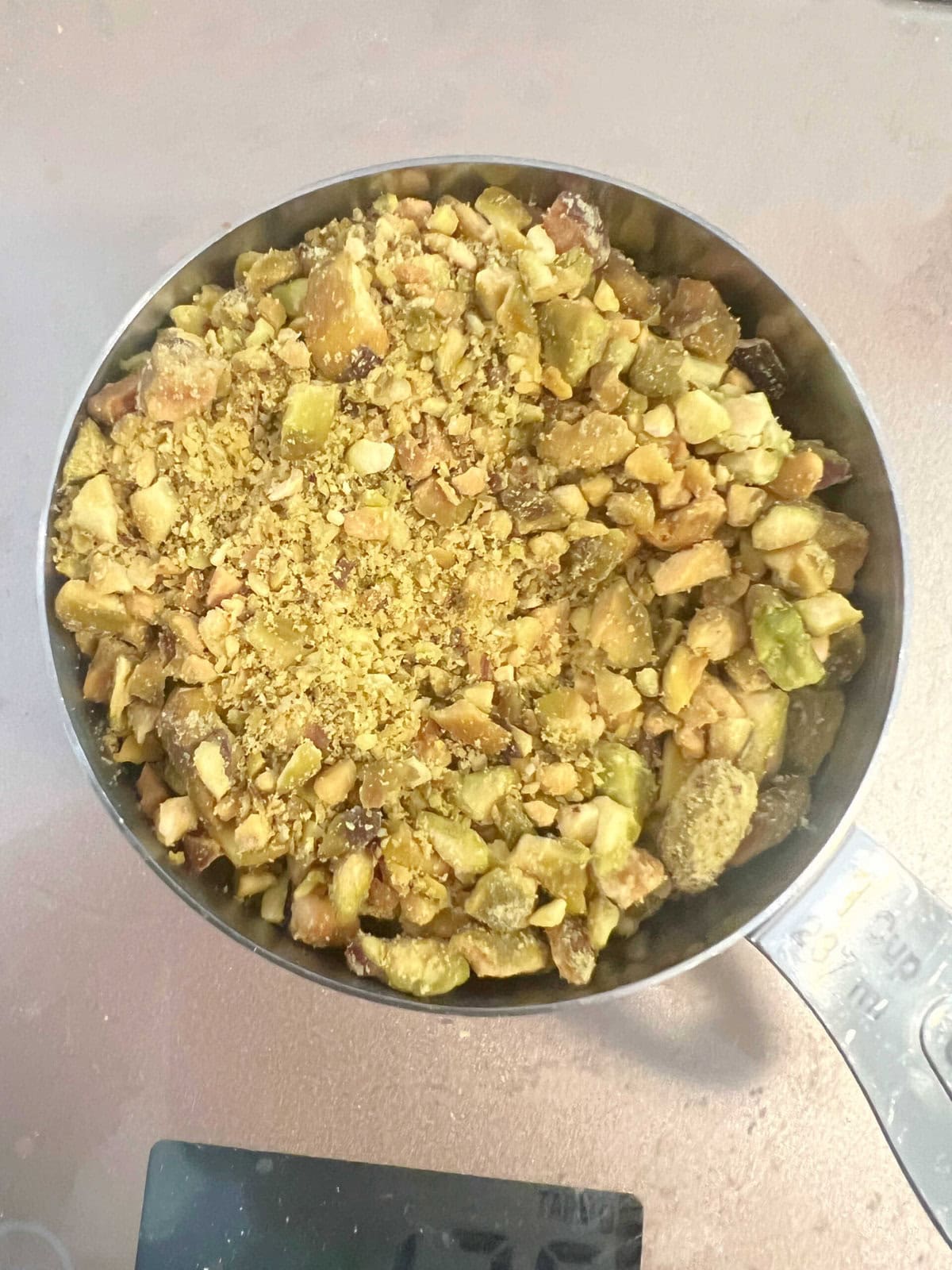 Cup of crushed pistachios.