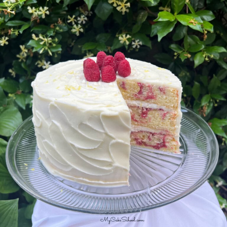 Sliced Lemon Raspberry Swirl Cake on a pedestal.