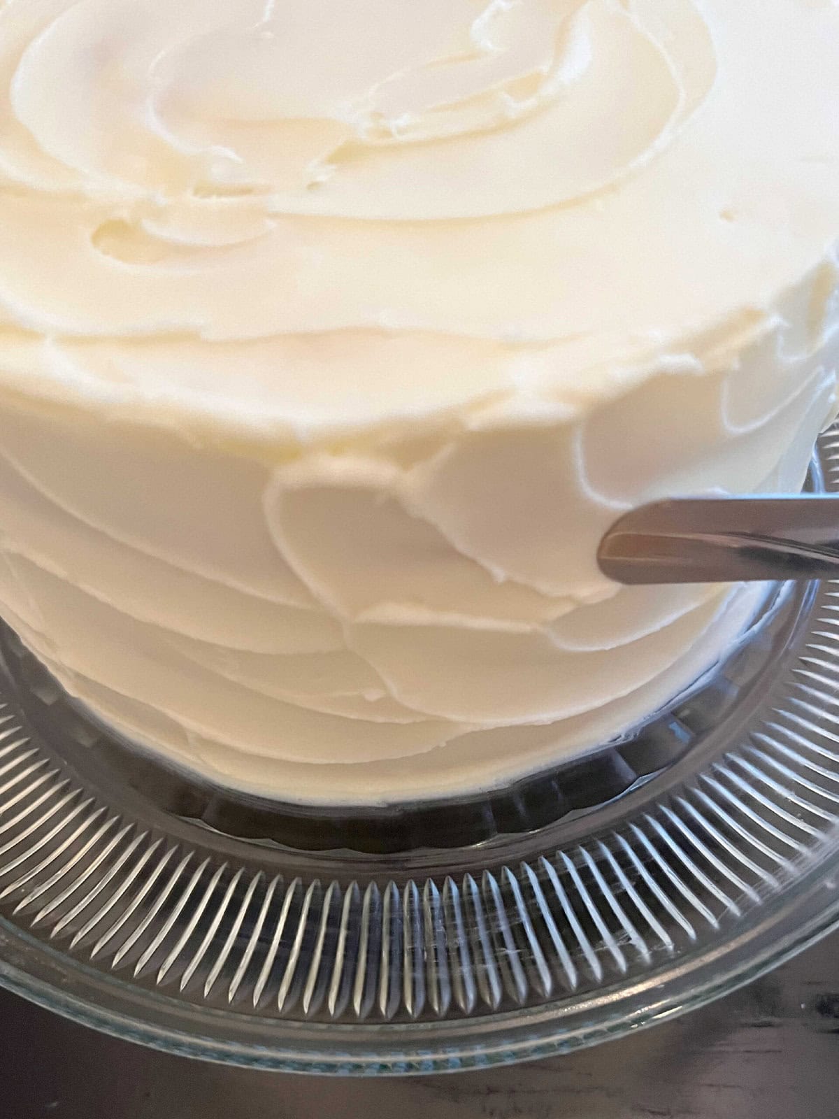 Frosting the Lemon Raspberry Swirl Cake.