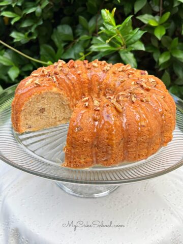 Banana Nut Bundt Cake, sliced, on a cake pedestal.