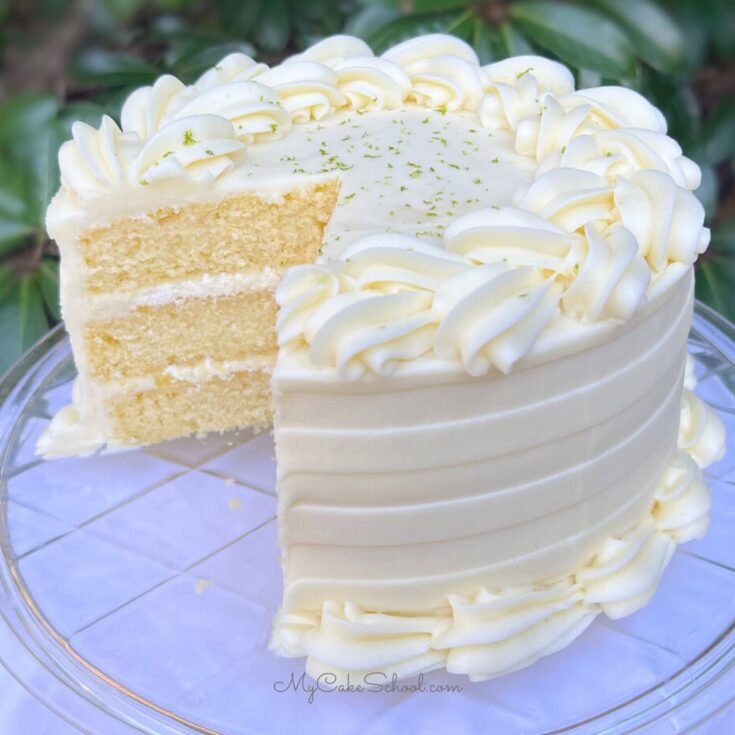 Key Lime Cake, sliced, on a cake pedestal.
