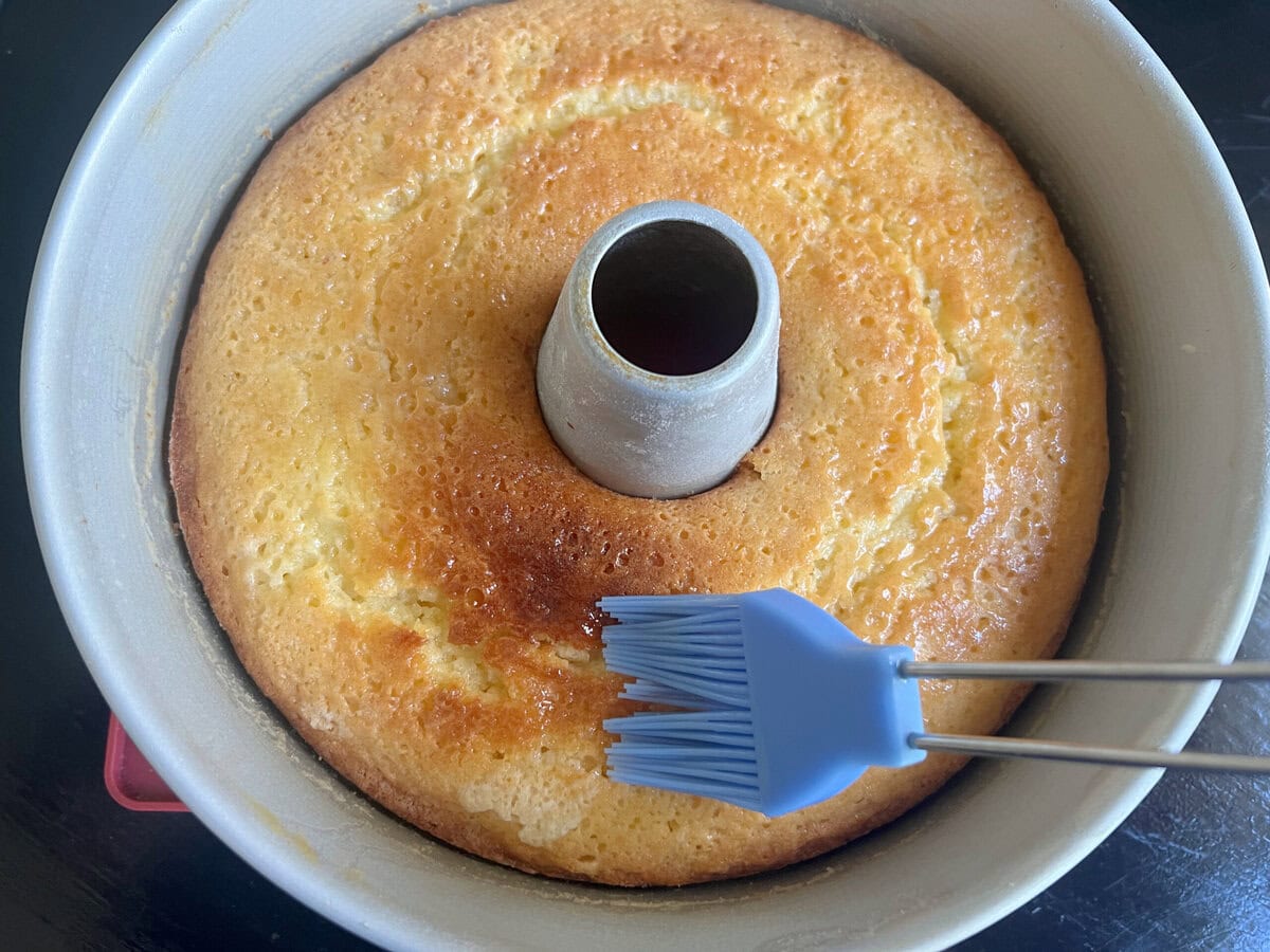 Glazing the margarita pound cake while still in the pan.