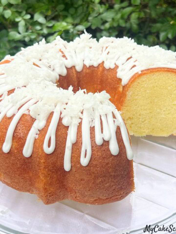 Coconut Bundt Cake, sliced, on a cake plate.
