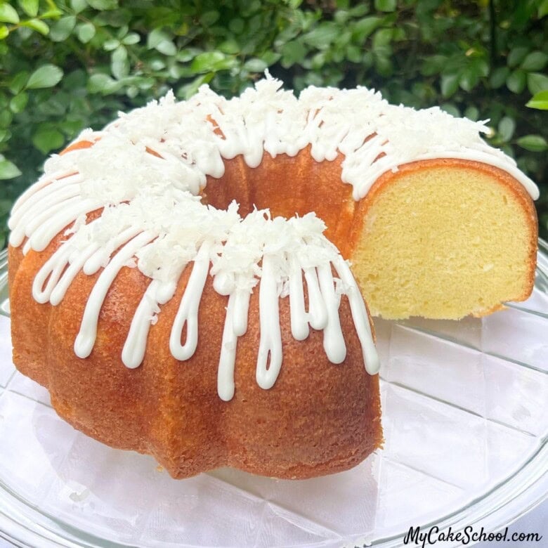 Coconut Bundt Cake, sliced, on a cake plate.
