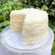 Easy Coconut Cake, sliced on a cake plate.