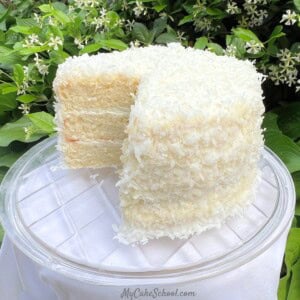 Easy Coconut Cake, sliced on a cake plate.