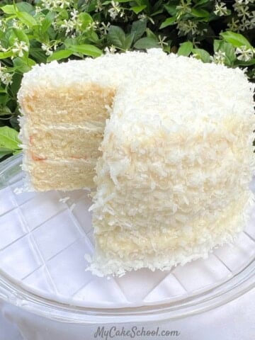 Easy Coconut Cake, sliced on a cake plate.