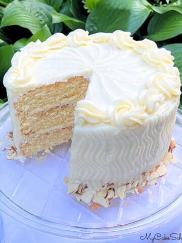 Amaretto Cake, sliced, on a cake plate.