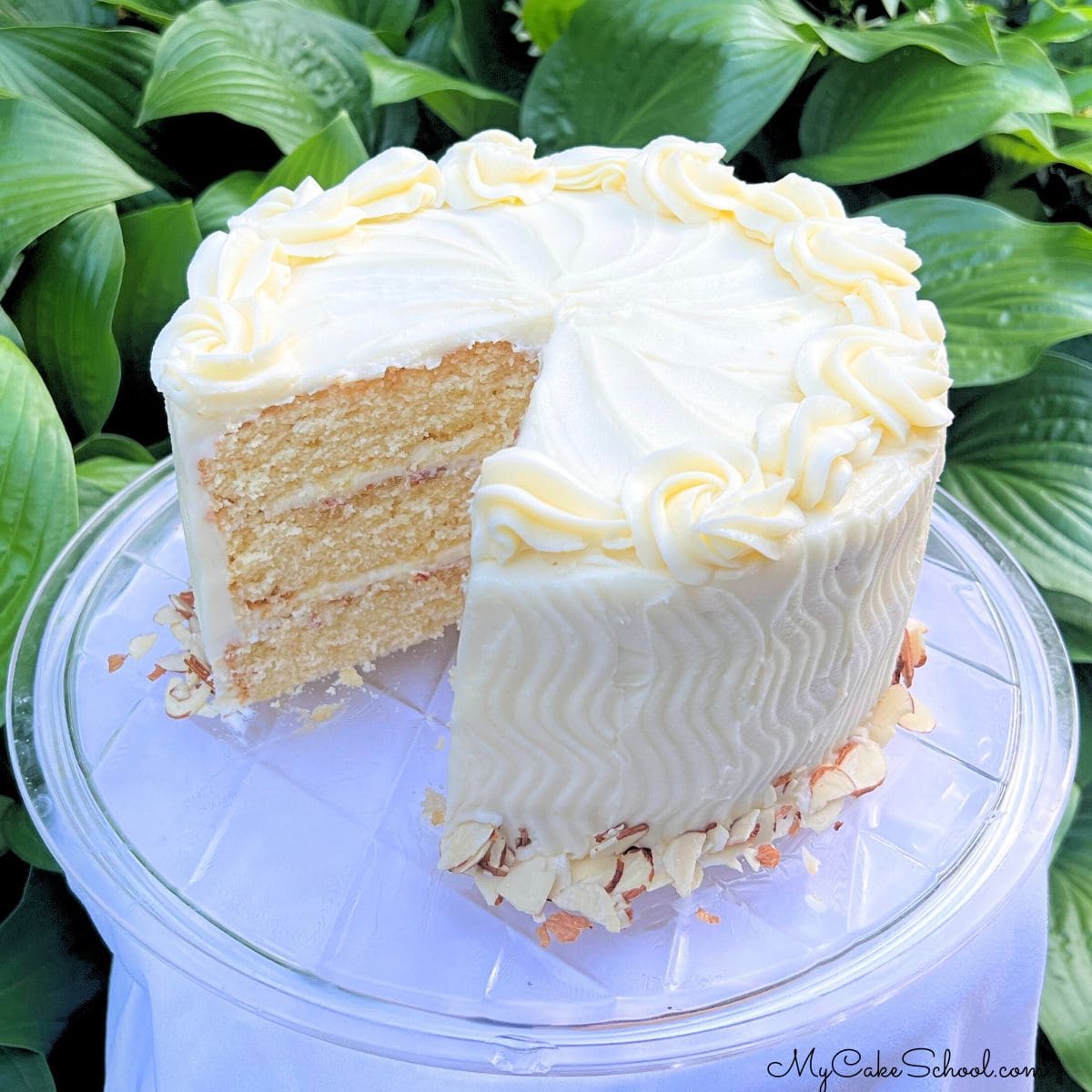 Amaretto Cake, sliced, on a cake plate.