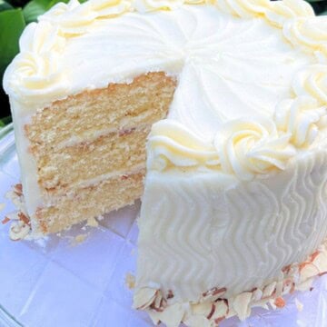 Amaretto cake, sliced, on a cake plate.