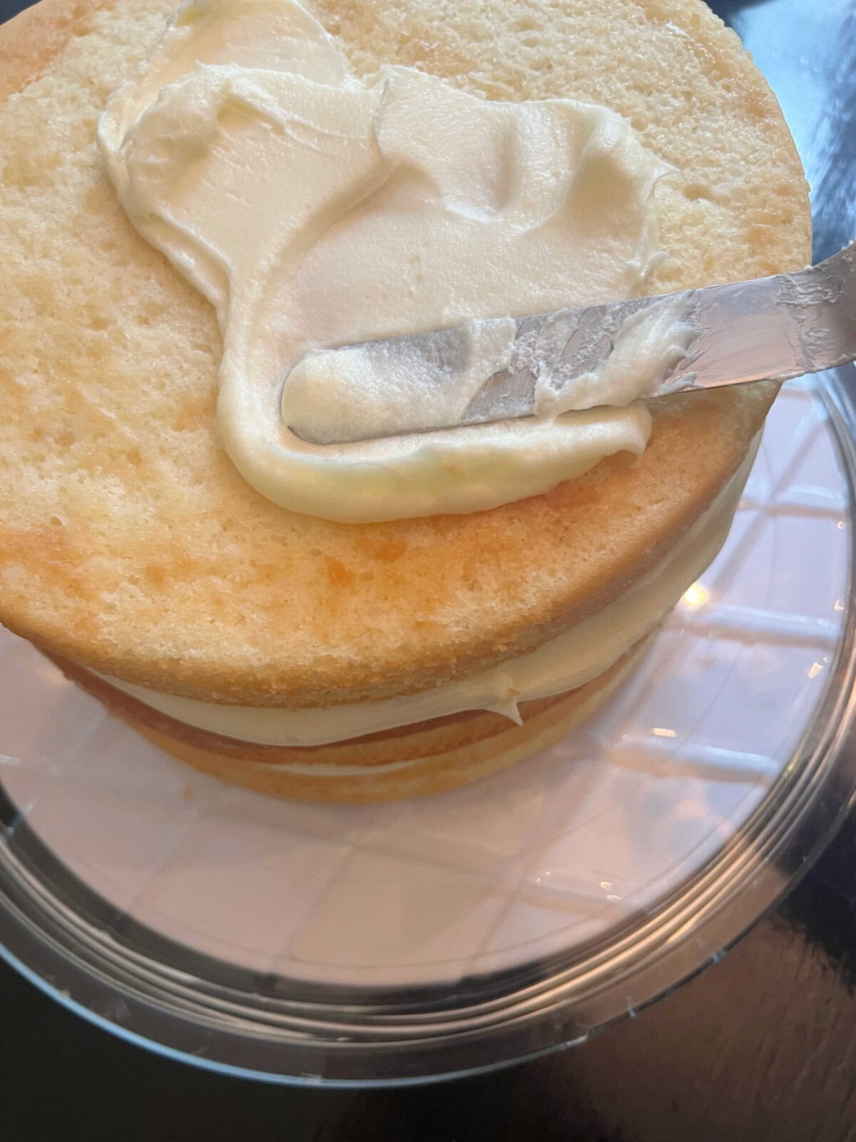 Frosting the Easy Coconut Cake.