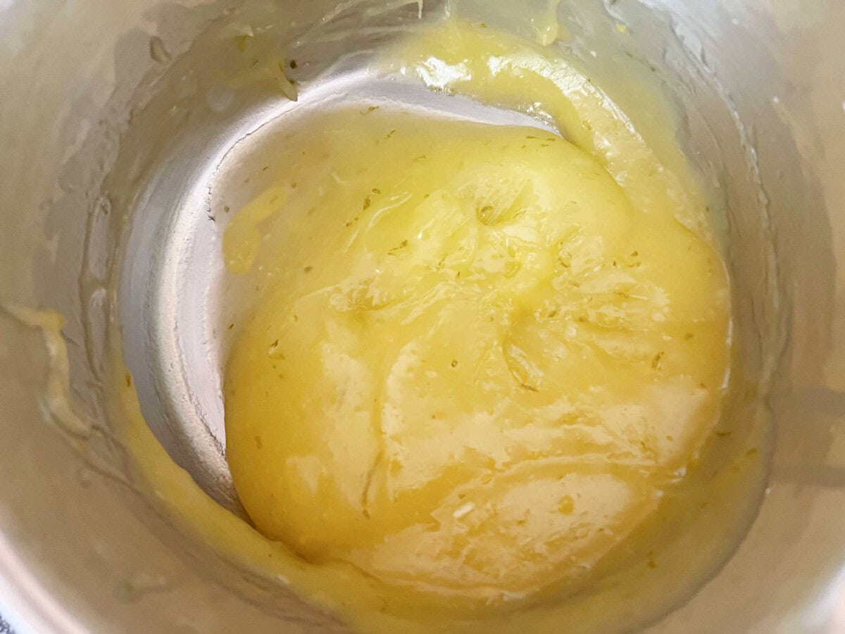 Lime Curd, thickened, in a saucepan.
