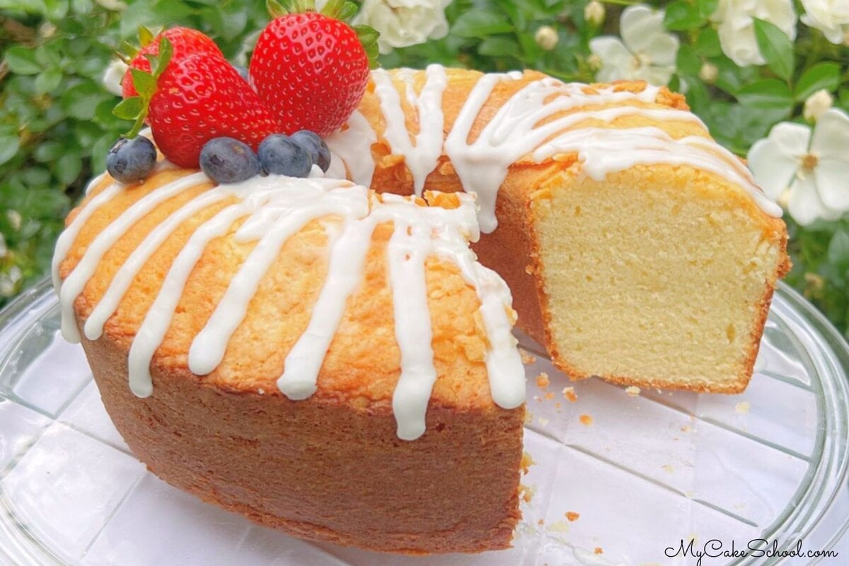 Ricotta cake, sliced, on a pedestal.