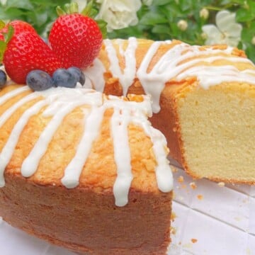 Ricotta cake, sliced, on a cake pedestal.