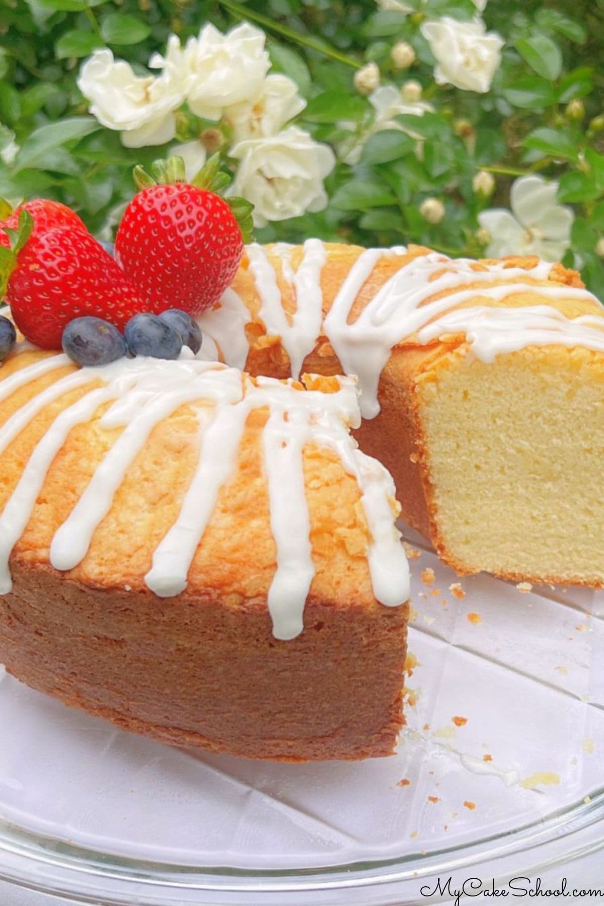 Ricotta cake, sliced, on a cake pedestal.