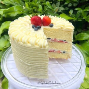 Berry Mascarpone Cake, sliced, on a cake plate.