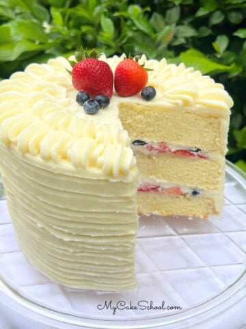 Berry Mascarpone Cake, sliced, on a cake plate.