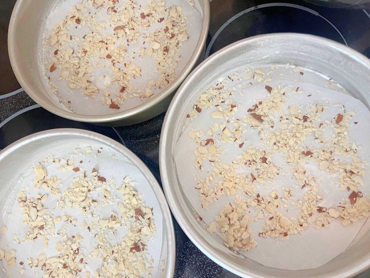 Crushed almonds in the bottom of cake pans.