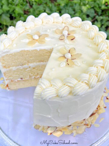 Sliced Easy Almond Cake from cake mix, on a pedestal.