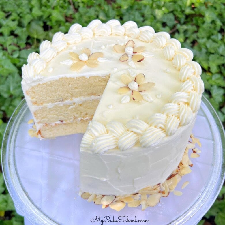 Sliced Easy Almond Cake from cake mix, on a pedestal.
