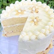 Easy Almond Cake, sliced, on a cake pedestal.