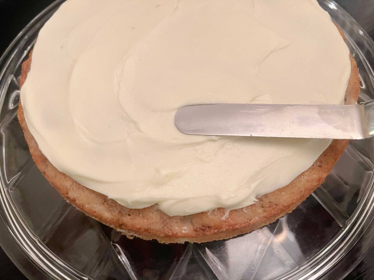 Hummingbird cake layer spread with cream cheese frosting.