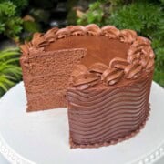 Coca Cola Cake, sliced, on a pedestal.