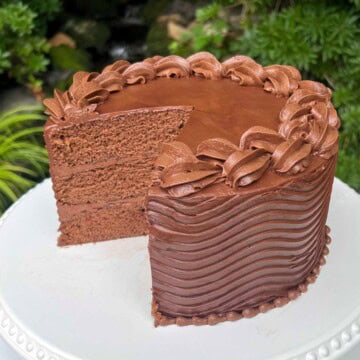 Coca Cola Cake, sliced, on a pedestal.