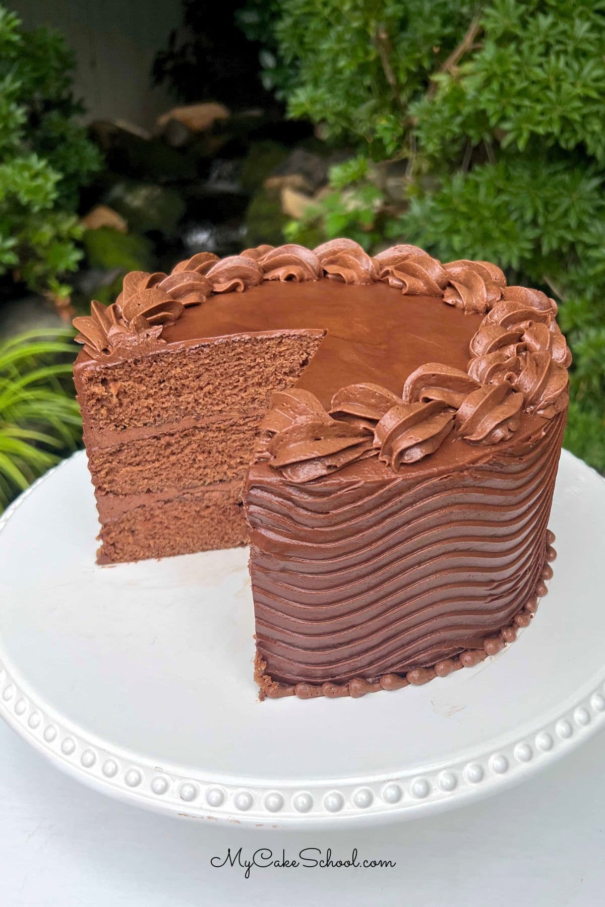 Coca Cola Cake, sliced, on a pedestal.