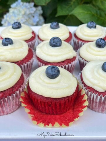 Red Velvet Cupcakes, topped with cream cheese frosting and blueberries.