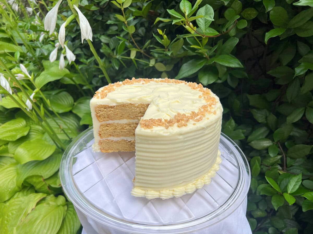 Brown Sugar Cake, sliced, on a pedestal.