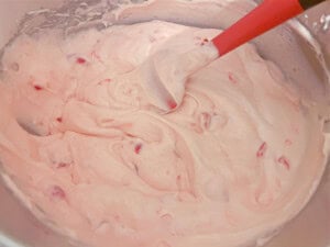 Stirring cherries into the Cherry Velvet Cake batter.