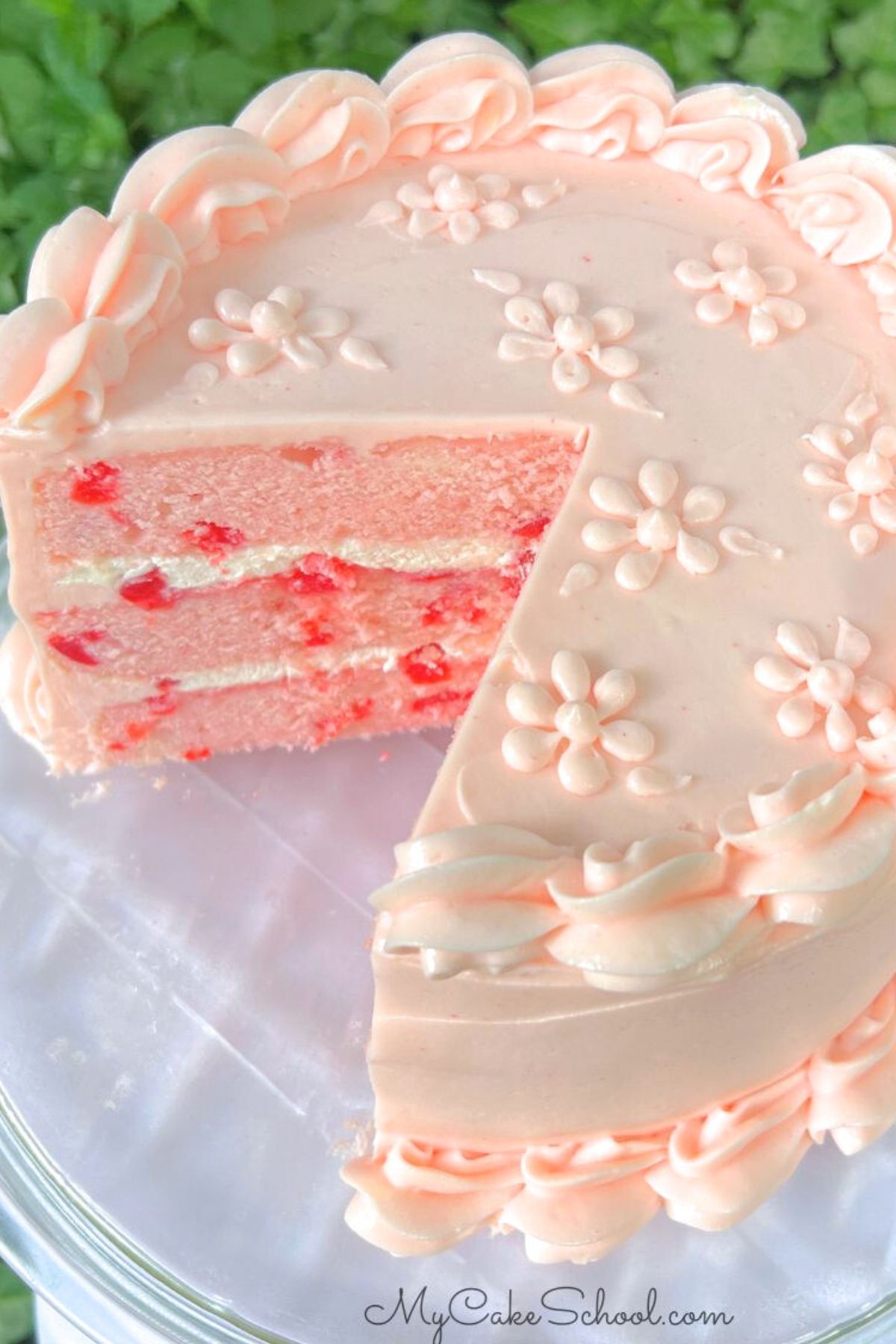 Cherry Velvet Cake, sliced, on a pedestal.