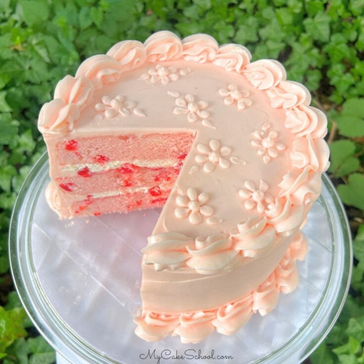 Cherry Velvet Cake, sliced, on a cake pedestal.