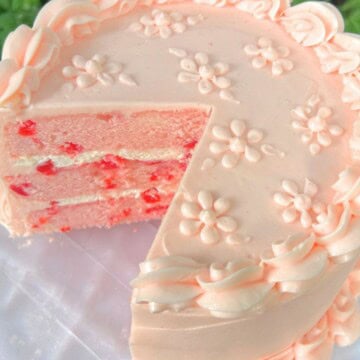 Cherry Velvet Cake, sliced, on a cake plate.