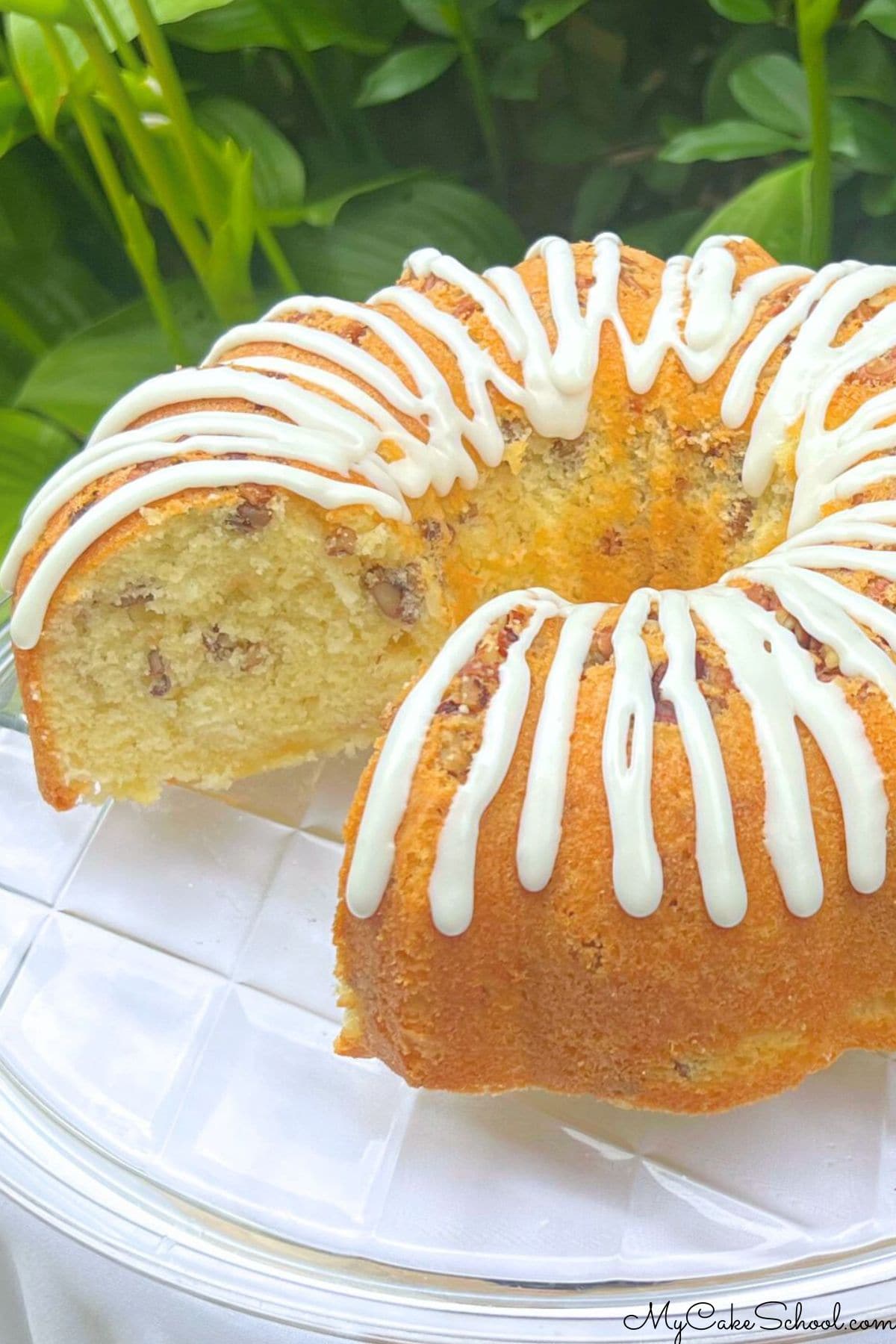 Coconut Pecan Cake, sliced, on a cake plate.