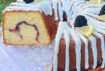 Lemon Blackberry Pound Cake, sliced, on a cake plate.