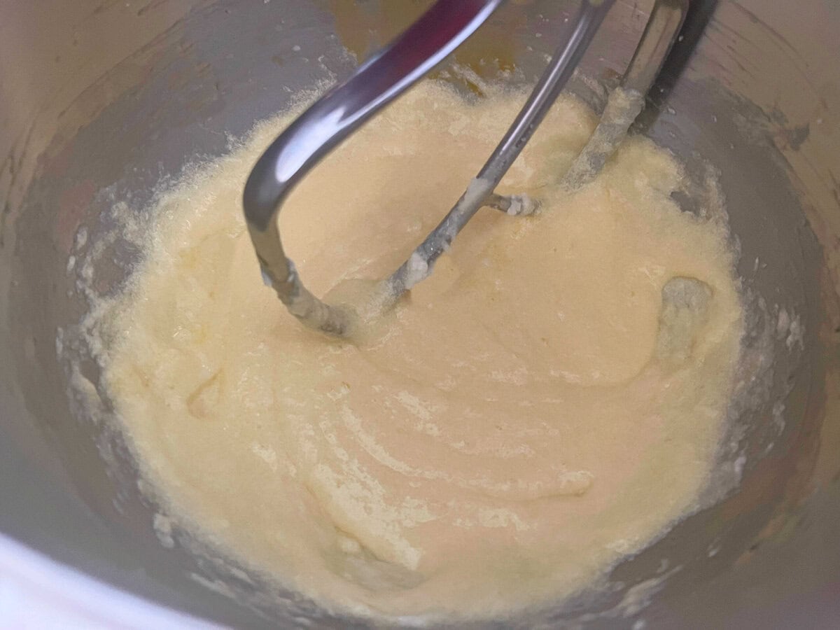 Mixing eggs into batter.